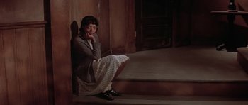 Movie still from “Lady Sings the Blues” (1972), directed by Sidney J. Furie – A woman sitting on the steps of a house; Medium shot, High angle