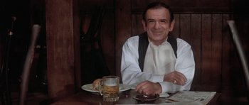 Movie still from “Lady Sings the Blues” (1972), directed by Sidney J. Furie – A man sitting at a table with a glass of beer; Medium shot, High angle