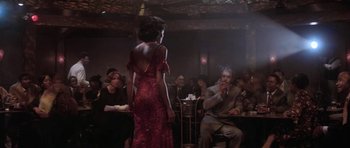 Movie still from “Lady Sings the Blues” (1972), directed by Sidney J. Furie – A woman in a red dress standing in front of a man; Wide shot, Over the shoulder angle