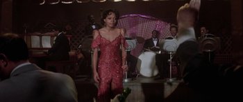 Movie still from “Lady Sings the Blues” (1972), directed by Sidney J. Furie – A woman in a red dress standing in front of an audience; Medium shot, Over the shoulder angle