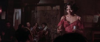 Movie still from “Lady Sings the Blues” (1972), directed by Sidney J. Furie – A group of people sitting in a room; Medium shot, Over the shoulder angle