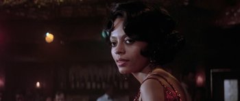 Movie still from “Lady Sings the Blues” (1972), directed by Sidney J. Furie – A woman in a red dress is posing for a picture; Close Up shot, Over the shoulder angle