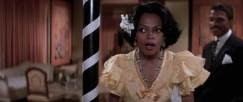 Movie still from “Lady Sings the Blues” (1972), directed by Sidney J. Furie – A woman with a flower in her hair and a flower in her hair; Close Up shot, Over the shoulder angle