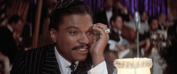 Movie still from “Lady Sings the Blues” (1972), directed by Sidney J. Furie – A person wearing a suit and tie; Close Up shot, Over the shoulder angle