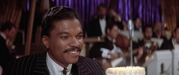 Movie still from “Lady Sings the Blues” (1972), directed by Sidney J. Furie – A person wearing a suit and tie; Close Up shot, Over the shoulder angle