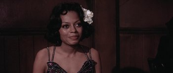 Movie still from “Lady Sings the Blues” (1972), directed by Sidney J. Furie – A woman with a flower in her hair; Close Up shot, Over the shoulder angle