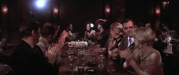 Movie still from “Lady Sings the Blues” (1972), directed by Sidney J. Furie – A group of people sitting at a table with drinks; Medium shot, High angle
