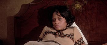 Movie still from “Lady Sings the Blues” (1972), directed by Sidney J. Furie – A woman sitting on a couch in a room; Close Up shot, High angle