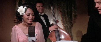 Movie still from “Lady Sings the Blues” (1972), directed by Sidney J. Furie – A man and woman playing a musical instrument; Close Up shot, Over the shoulder angle