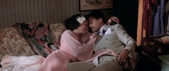 Movie still from “Lady Sings the Blues” (1972), directed by Sidney J. Furie – A man and a woman sitting on a couch together; Medium shot, High angle