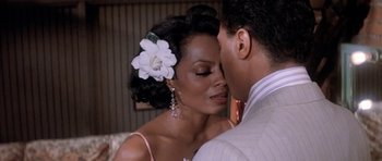 Movie still from “Lady Sings the Blues” (1972), directed by Sidney J. Furie – A man and a woman kissing each other in front of a mirror; Close Up shot, Over the shoulder angle