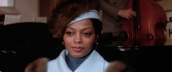 Movie still from “Lady Sings the Blues” (1972), directed by Sidney J. Furie – A person wearing a hat and a coat; Close Up shot, Low angle