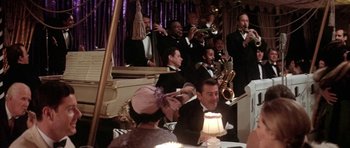 Movie still from “Lady Sings the Blues” (1972), directed by Sidney J. Furie – A group of men and women in suits and hats; Wide shot, High angle