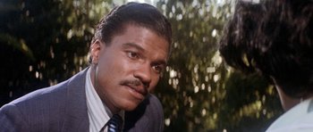 Movie still from “Lady Sings the Blues” (1972), directed by Sidney J. Furie – A person wearing a suit and tie; Close Up shot, Over the shoulder angle