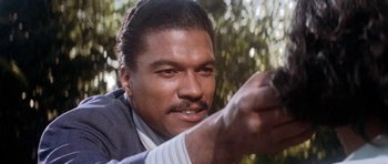 Movie still from “Lady Sings the Blues” (1972), directed by Sidney J. Furie – A person holding a gun in his hand; Close Up shot, Low angle