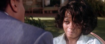 Movie still from “Lady Sings the Blues” (1972), directed by Sidney J. Furie – An older woman is sitting in front of a man; Close Up shot, Over the shoulder angle