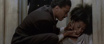 Movie still from “Lady Sings the Blues” (1972), directed by Sidney J. Furie – A man in a suit and tie looking at a woman in a white shirt; Close Up shot, Over the shoulder angle