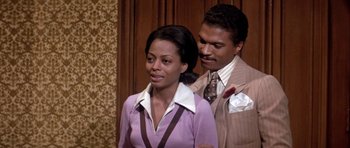 Movie still from “Lady Sings the Blues” (1972), directed by Sidney J. Furie – A man and a woman standing next to each other; Medium shot, Over the shoulder angle