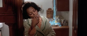 Movie still from “Lady Sings the Blues” (1972), directed by Sidney J. Furie – A woman smoking a cigarette while wearing a robe; Close Up shot, Low angle