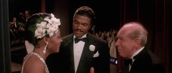 Movie still from “Lady Sings the Blues” (1972), directed by Sidney J. Furie – A man in a tuxedo talking to two other people; Close Up shot, High angle