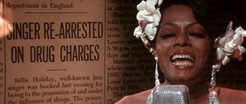 Movie still from “Lady Sings the Blues” (1972), directed by Sidney J. Furie – A woman in a white dress and a white flower in her hair; Extreme Close Up shot, High angle