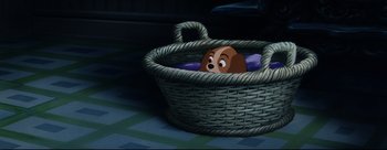 Movie still from “Lady and the Tramp” (1955), directed by Clyde Geronimi – A dog is sitting in a basket on the ground; Wide shot, High angle