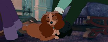 Movie still from “Lady and the Tramp” (1955), directed by Clyde Geronimi – Lady and the tramp dog sitting next to each other on the floor; Close Up shot, High angle