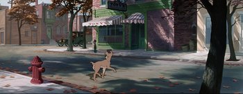 Movie still from “Lady and the Tramp” (1955), directed by Clyde Geronimi – A dog walking down the sidewalk in front of a building; Wide shot, High angle