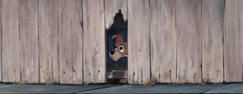 Movie still from “Lady and the Tramp” (1955), directed by Clyde Geronimi – A dog looking out of a window in a barn; Wide shot, Low angle