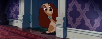 Movie still from “Lady and the Tramp” (1955), directed by Clyde Geronimi – A dog that is sitting in front of a door; Close Up shot, Over the shoulder angle