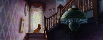 Movie still from “Lady and the Tramp” (1955), directed by Clyde Geronimi – A dog sitting on the stairs of a house; Wide shot, Low angle