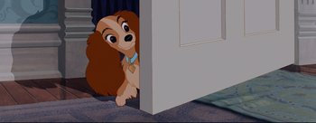 Movie still from “Lady and the Tramp” (1955), directed by Clyde Geronimi – A dog is hiding behind a door; Medium shot, Over the shoulder angle