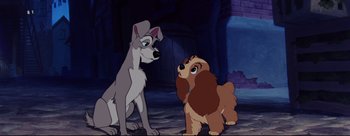 Movie still from “Lady and the Tramp” (1955), directed by Clyde Geronimi – A dog and a puppy looking at one another; Wide shot, Low angle