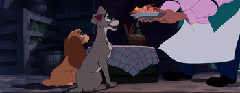 Movie still from “Lady and the Tramp” (1955), directed by Clyde Geronimi – Lady and the tramp sitting in front of a plate of food; Medium shot, Over the shoulder angle