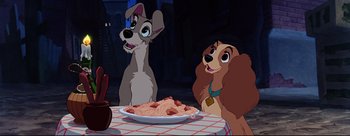 Movie still from “Lady and the Tramp” (1955), directed by Clyde Geronimi – Lady and the tramp are sitting at a table with a plate of spaghetti; Wide shot, Low angle