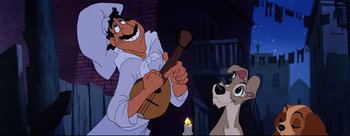 Movie still from “Lady and the Tramp” (1955), directed by Clyde Geronimi – A man and a dog are playing a musical instrument together; Medium shot, Low angle