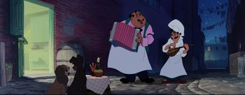Movie still from “Lady and the Tramp” (1955), directed by Clyde Geronimi – A man holding an accordion in front of two other men; Wide shot, Low angle
