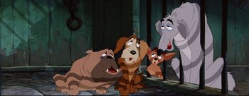 Movie still from “Lady and the Tramp” (1955), directed by Clyde Geronimi – A group of cartoon dogs sitting next to each other on the ground; Wide shot, High angle