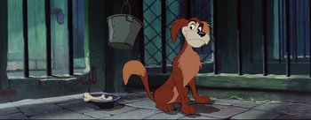 Movie still from “Lady and the Tramp” (1955), directed by Clyde Geronimi – A dog sitting on the floor next to a bucket of food; Medium shot, High angle