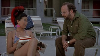 Movie still from “Lady in the Water” (2006), directed by M. Night Shyamalan – A man and a woman sitting on a deck; Medium shot, Over the shoulder angle
