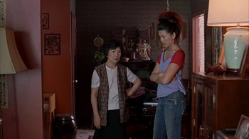 Movie still from “Lady in the Water” (2006), directed by M. Night Shyamalan – Two women are standing in a living room talking; Medium shot, High angle