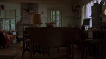 Movie still from “Lady in the Water” (2006), directed by M. Night Shyamalan – A bowl of fruit sits on a wooden table; Wide shot, High angle