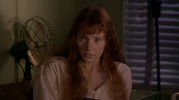 Movie still from “Lady in the Water” (2006), directed by M. Night Shyamalan – A woman with long red hair sitting in a room; Close Up shot, Low angle