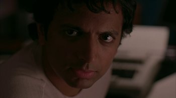 Movie still from “Lady in the Water” (2006), directed by M. Night Shyamalan – A man's face in the dark; Close Up shot, Low angle