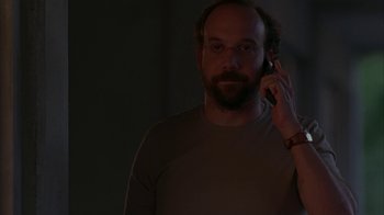 Movie still from “Lady in the Water” (2006), directed by M. Night Shyamalan – A man with a beard is talking on a cell phone; Medium shot, Low angle