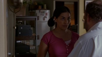 Movie still from “Lady in the Water” (2006), directed by M. Night Shyamalan – A young woman with ear buds in her ears; Close Up shot, Over the shoulder angle