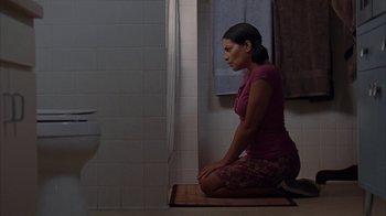 Movie still from “Lady in the Water” (2006), directed by M. Night Shyamalan – A woman sitting on the floor of a bathroom; Medium shot, High angle