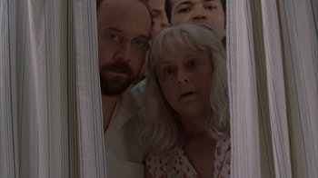 Movie still from “Lady in the Water” (2006), directed by M. Night Shyamalan – A group of people standing in front of a mirror; Medium shot, Low angle