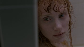 Movie still from “Lady in the Water” (2006), directed by M. Night Shyamalan – A person with curly red hair; Close Up shot, Low angle