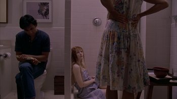 Movie still from “Lady in the Water” (2006), directed by M. Night Shyamalan – A woman sitting on a toilet in a bathroom; Medium shot, High angle